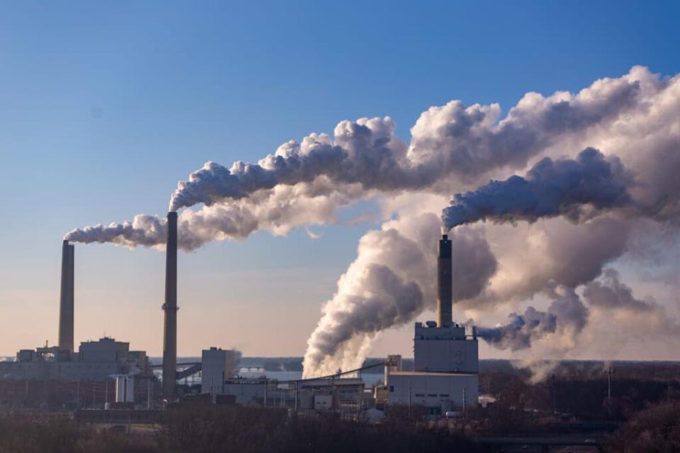 Wind blows pollution from a coal-burning power plant. The recently signed Inflation Reduction Act includes language that gives the Environmental Protection Agency more power to regular greenhouse gases. (Getty Images)