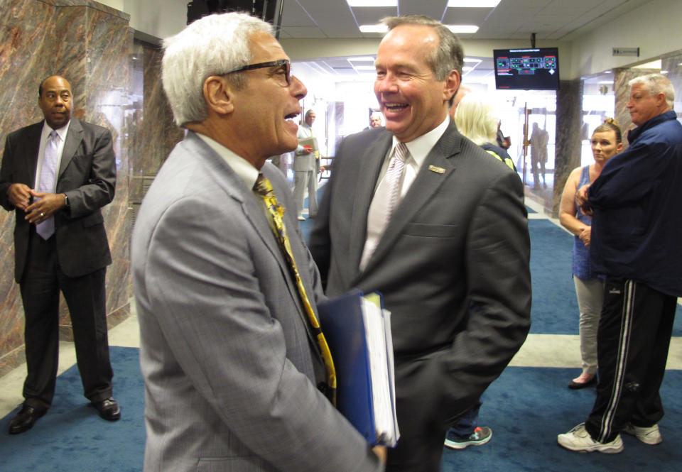 Commissioner of Higher Education Joseph Rallo, left, talks with LSU President F. King Alexander ahead of a House budget hearing on public college financing, on Tuesday, April 3, 2018, in Baton Rouge, La. (AP Photo/Melinda Deslatte)