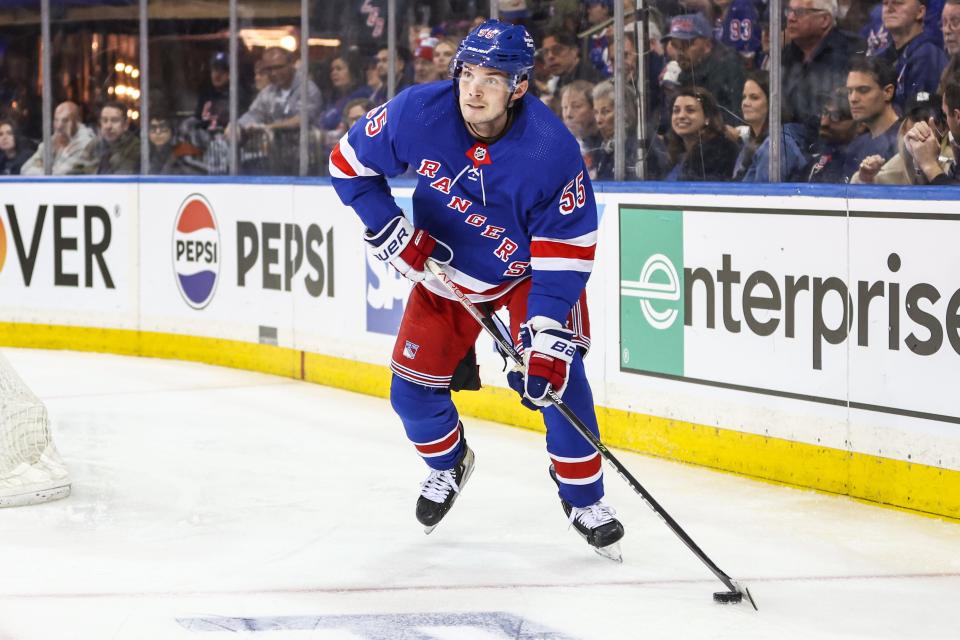 Apr 21, 2024; New York, New York, USA; New York Rangers defenseman Ryan Lindgren (55) controls the puck in the third period against the Washington Capitals in game one of the first round of the 2024 Stanley Cup Playoffs at Madison Square Garden.