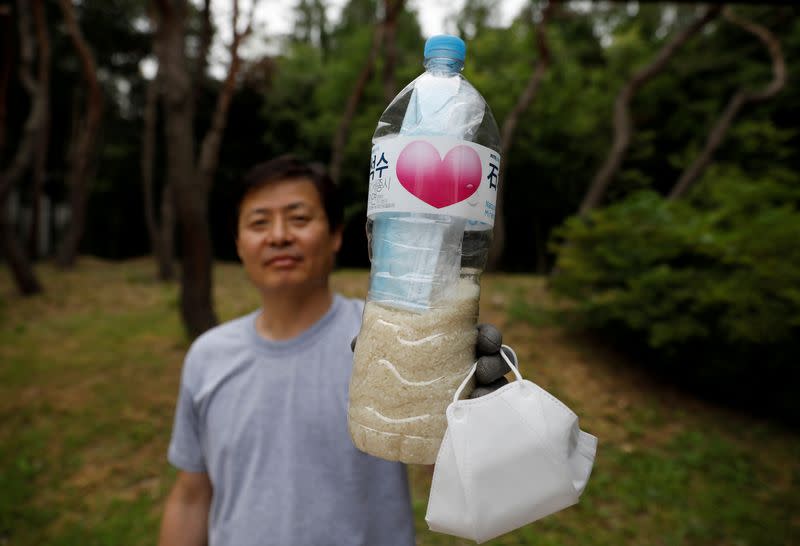 FILE PHOTO: North Korean defector group prepares plastic bottles filled with rice and masks to be sent towards North Korea