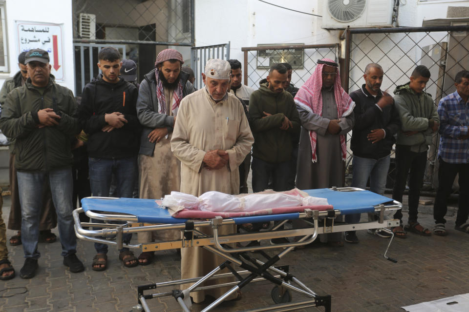 Palestinians mourn over the bodies of relatives killed in the Israeli bombardment of the Gaza Strip in Rafah on Friday, Nov. 17, 2023. (AP Photo/Hatem Ali)