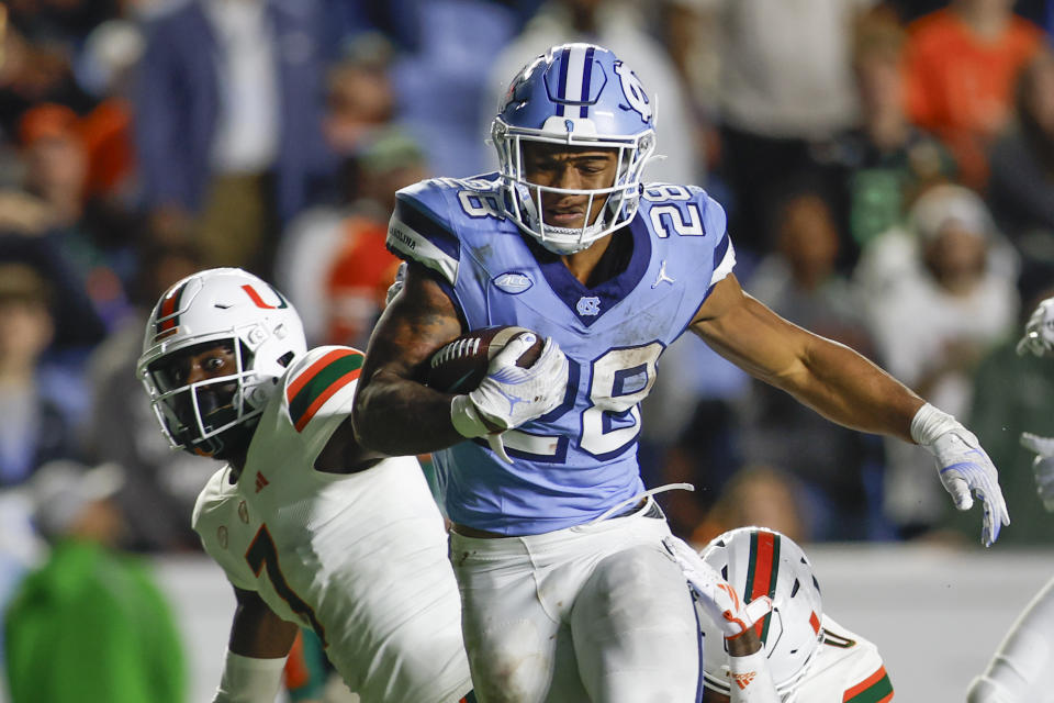 Oct 14, 2023; Chapel Hill, North Carolina, USA; North Carolina Tar Heels running back Omarion Hampton (28) carries the ball against the Miami Hurricanes in the second half at Kenan Memorial Stadium. Mandatory Credit: Nell Redmond-USA TODAY Sports