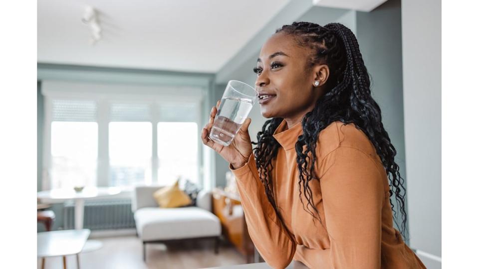 Photo of a young African-American woman drinking water