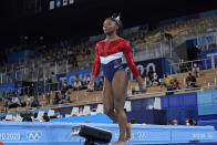 Simone Biles, of the United States, walks after performing on the vault during the artistic gymnastics women's final at the 2020 Summer Olympics, Tuesday, July 27, 2021, in Tokyo. (AP Photo/Ashley Landis)