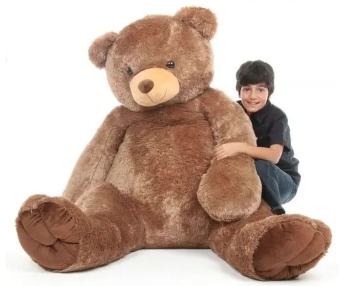 A kid hugging a giant teddy bear