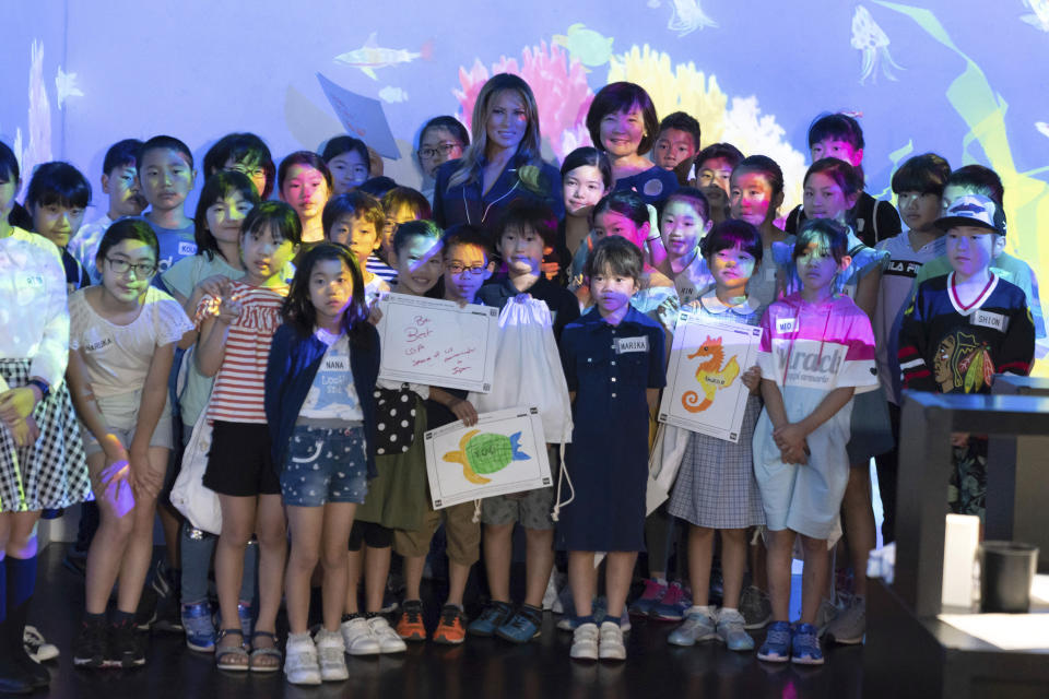 U.S. first lady Melania Trump poses with Akie Abe, center right, wife of Japanese Prime Minister Shinzo Abe, and children for a photo during a visit to a digital art museum in Tokyo Sunday, May 26, 2019. (Pierre-Emmanuel Deletree/Pool Photo via AP)