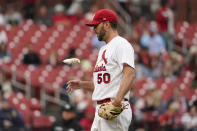St. Louis Cardinals starting pitcher Adam Wainwright tosses a rosin bag during the first inning of a baseball game against the Milwaukee Brewers Thursday, May 26, 2022, in St. Louis. (AP Photo/Jeff Roberson)