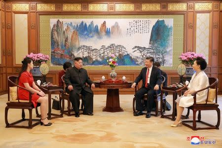 Chinese President Xi Jinping talks with North Korean leader Kim Jong Un during his visit in Beijing, China, in this undated photo released June 20, 2018 by North Korea's Korean Central News Agency. KCNA via REUTERS