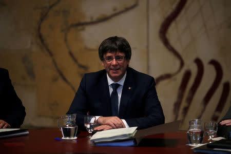 Catalan President Carles Puigdemont smiles as he chairs a meeting of the regional government at the Palau de la Generalitat, the regional government headquarters, in Barcelona, Spain September 26, 2017. REUTERS/Jon Nazca