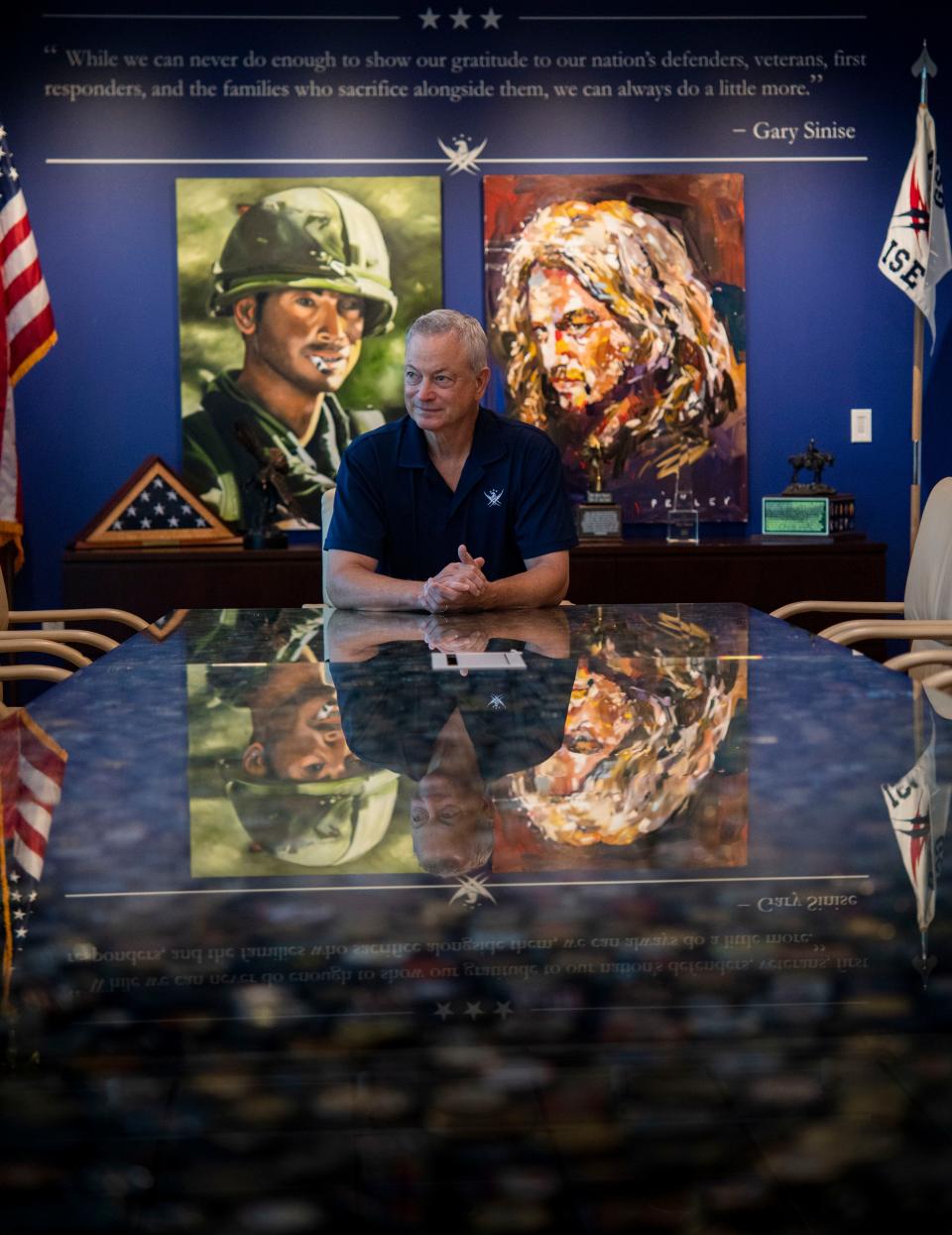 Actor/nonprofit founder Gary Sinise sits in front of an artist's paintings of his Lt. Dan character from the movie 'Forrest Gump' at Gary Sinise Foundation headquarters in Franklin, Tenn., June 28, 2024