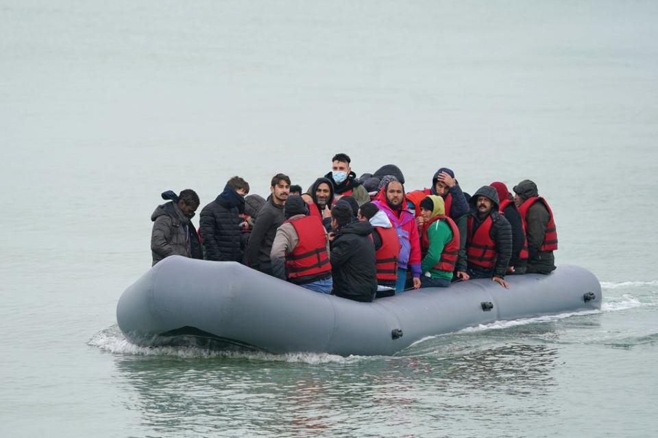 A dinghy carrying people thought to be migrants, arrives on a beach in Dungeness, Kent (Gareth Fuller/PA) (PA Wire)