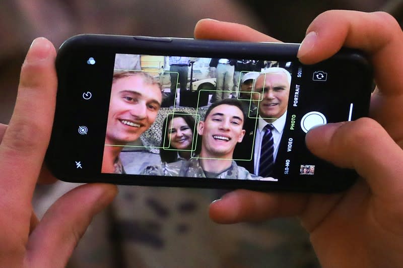 U.S. Vice President Mike Pence and his wife Karen pose for a selfie with U.S. troops at Al Asad Air Base