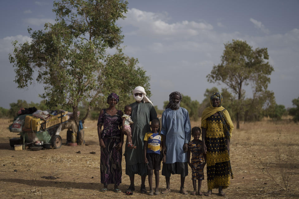 Amadou Altine Ndiaye, 48, center right, stands for a portrait with his family where they set up camp in the village of Dendoudy Dow, in the Matam region of Senegal, Monday, April 17, 2023. From left are his daughter, Houraye Ndiaye, 20; granddaughter Aissata, 2; son-in-law, Moussa Ifra Ba, 28; son, Mamadou, 8; daughter, Aminata, 5, and his wife, Maray Kalidou Ndiaye, 50. Ba and Houraye want to expand their family. They mused about a future in which at least one child stays in pastoralism while at least one goes to school. “I’d like my children to keep up with the changing world,” Ba says. (AP Photo/Leo Correa)