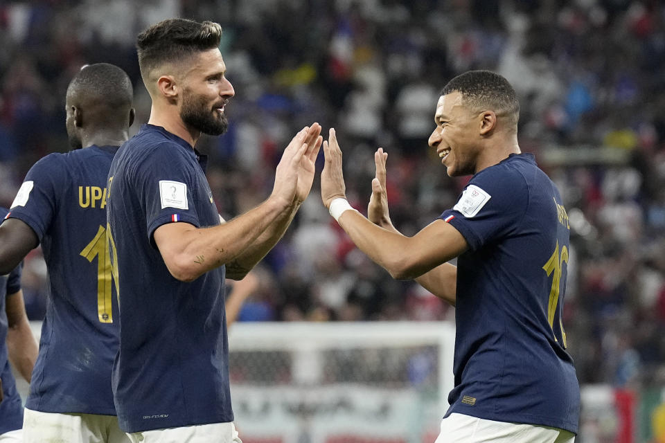 France's Olivier Giroud, left, and France's Kylian Mbappe celebrate after scoring their side's second goal during the World Cup round of 16 soccer match between France and Poland, at the Al Thumama Stadium in Doha, Qatar, Sunday, Dec. 4, 2022. (AP Photo/Martin Meissner)