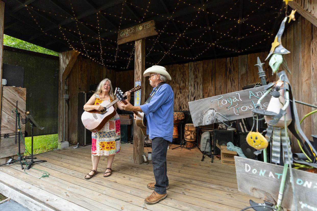 Maggie and Mike McKinney, both musicians, have a small stage and shelter for people to watch musical concerts on their property. They were away at a folk music festival when they first heard of the storm approaching in the Gulf.