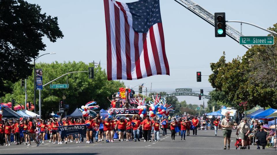 Modesto Junior College proceeds down I Street during the Independence Day Parade in Modesto, Calif., Tuesday, July 4, 2023. Andy Alfaro/aalfaro@modbee.com