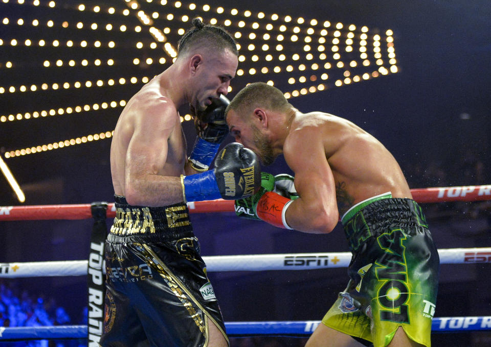 Vasiliy Lomachenko right, tries to tries to avoid a punch from Jose Pedraza in the WB lightweight title boxing match at Madison Square Garden, Saturday, Dec. 8, 2018, in New York. (AP Photo/Howard Simmons)