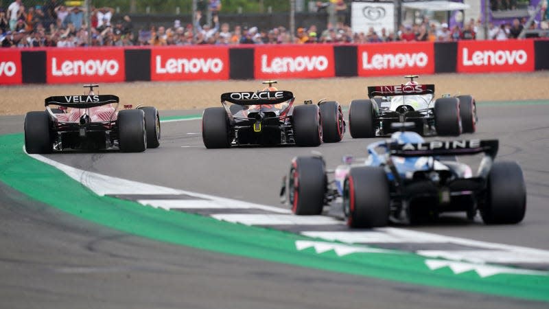 A photo of Lewis Hamilton, Charles Leclerc and Sergio Perez battling on track in F1. 