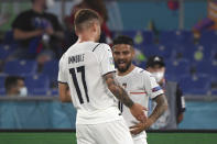 Italy's Lorenzo Insigne, right, celebrates with Italy's Ciro Immobile after scoring his side's third goal during the Euro 2020 soccer championship group A match between Italy and Turkey at the Olympic stadium in Rome, Friday, June 11, 2021. (Alberto Lingria/Pool Photo via AP)