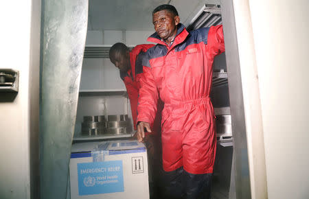 REFILE - REMOVING RESTRICTIONS Congolese Health Ministry officials arrange the first batch of experimental Ebola vaccines in Kinshasa, Democratic Republic of Congo May 16, 2018. REUTERS/Kenny Katombe