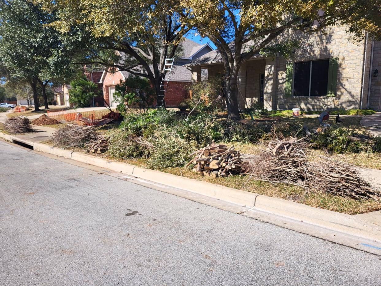 Limbs and branches await pickup in front of a Round Rock home following the ice storm this month.