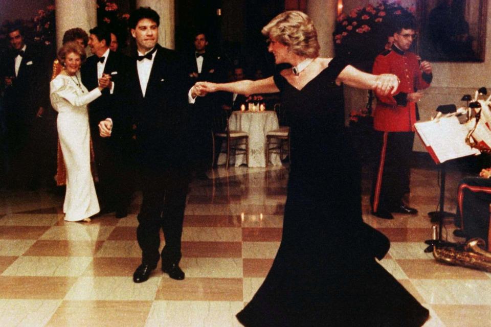 Princess Diana dancing at a November 9, 1985 White House dinner with actor John Travolta. The dress was featured in Diana's 1997 auction for charity, which is detailed in handwritten letters to be auctioned by Swann Auction Galleries this week. (REUTERS)