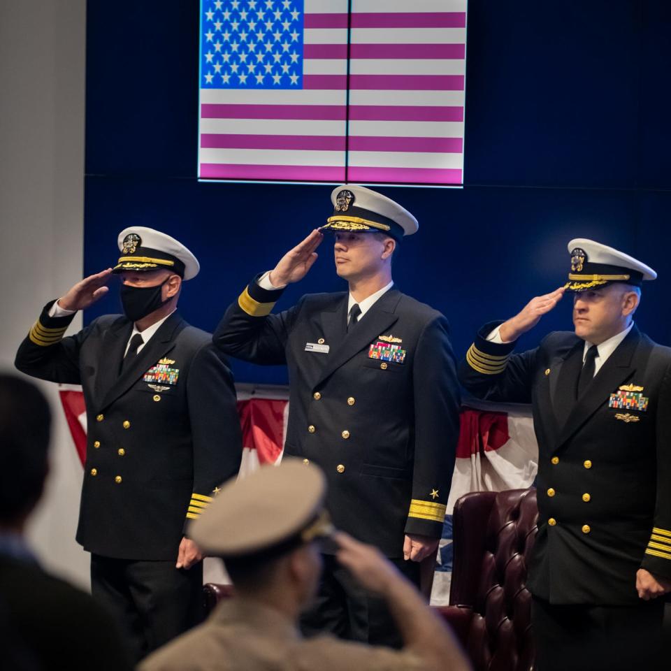 Capt. Tony Holmes, Rear Adm. Kevin Byrne and outgoing NSWC PHD Commanding Officer Capt. Andrew Hoffman salute during the change of command ceremony on Friday.