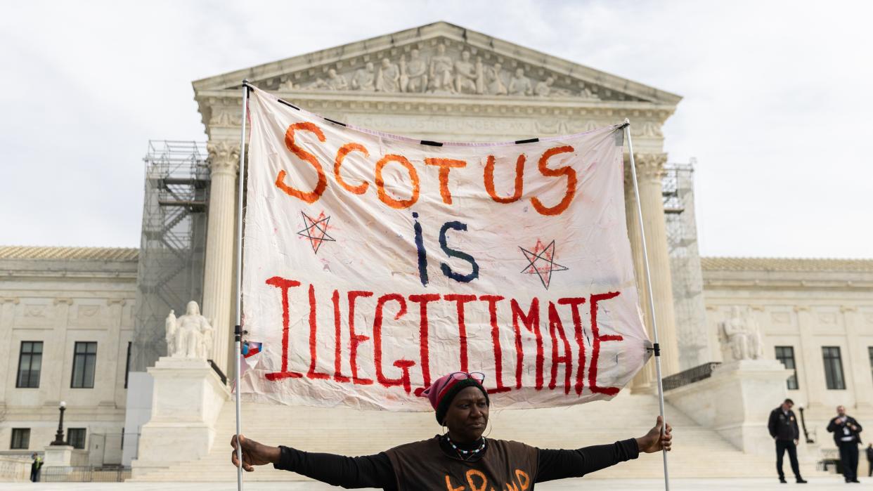  A protester outside the U.S. Supreme Court on February 8, 2024 in Washington, DC. The court heard oral arguments in a case on whether or not former President Trump can remain on the ballot in Colorado for the 2024 presidential election. . 