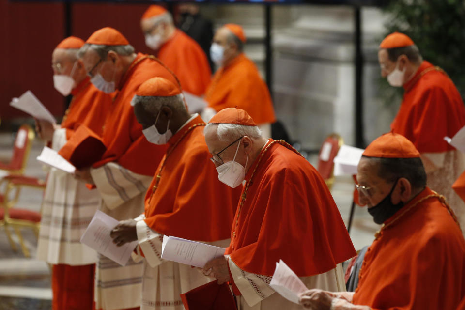 Cardinals wear protective masks as they attend a consistory ceremony where 13 bishops were elevated to a cardinal's rank in St. Peter’s Basilica at the Vatican, Saturday, Nov. 28, 2020. (Fabio Frustaci/POOL via AP)