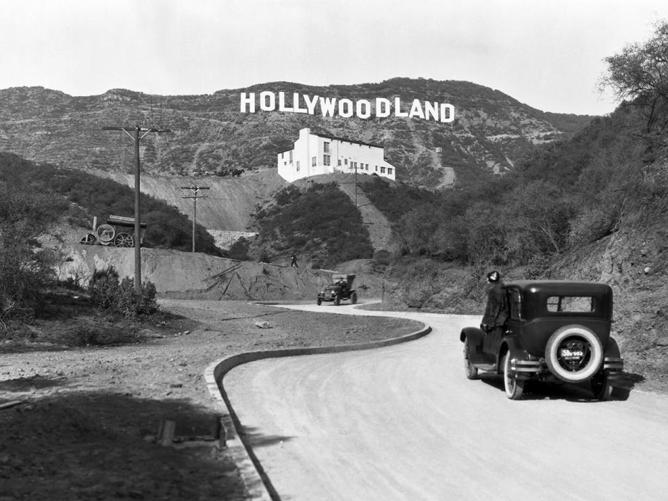 A sign advertises the opening of the Hollywoodland housing development in the hills on Mulholland Drive overlooking Los Angeles, c. 1924.  / Credit: Underwood Archives/Getty Images