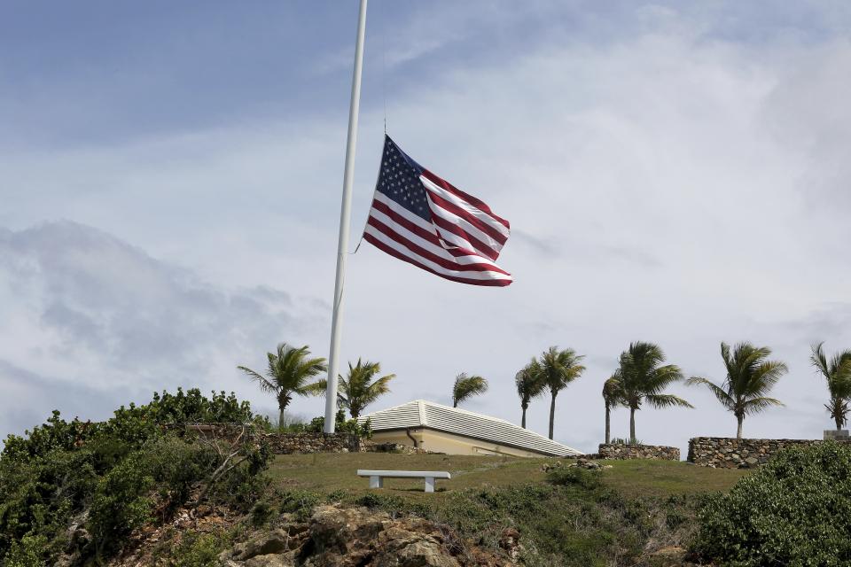 A U.S. flag flies at half staff on Little St. James Island, in the U. S. Virgin Islands, a property owned by Jeffrey Epstein, Wednesday, Aug. 14, 2019. Many in nearby St. Thomas are debating what should be done with the structures and even the islands themselves, even though it is unclear who would inherit Little St. James Island and neighboring Great St. James Island. (AP Photo/Gabriel Lopez Albarran)