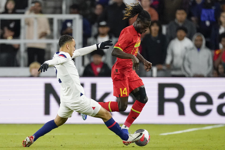 United States defender Sergino Dest, left, tries to take the ball from Ghana defender Gideon Mensah (14) during the first half of an international friendly soccer match Tuesday, Oct. 17, 2023, in Nashville, Tenn. (AP Photo/George Walker IV)