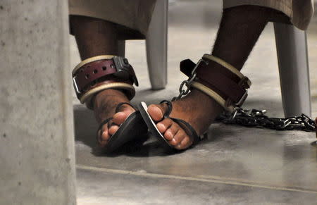 In this photo, reviewed by a U.S. Department of Defense official, a Guantanamo detainee's feet are shackled to the floor as he attends a "Life Skills" class inside the Camp 6 high-security detention facility at Guantanamo Bay U.S. Naval Base in this file pool photo taken April 27, 2010. REUTERS/Michelle Shephard/Pool