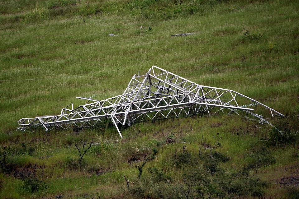 A twisted power distribution line tower is crumpled on the ground on Oct. 28, 2017, after the passing of Hurricane Maria in Guayama. (Photo: AFP Contributor via Getty Images)