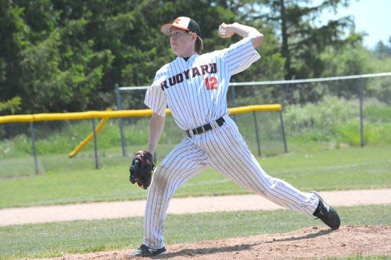 Brett Mayer (12) deals a pitch during a Rudyard baseball game last season. The Bulldogs are scheduled to open the 2022 season next week, weather permitting.