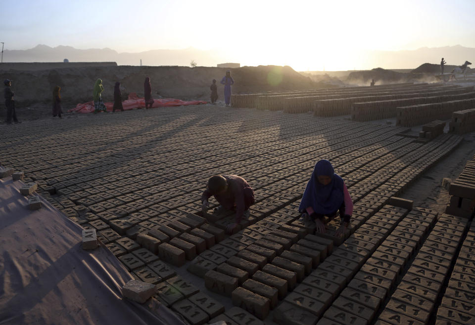 In this Wednesday, June 19, 2019, photo, Afghan children work at a brick factory on the outskirts of of Kabul, Afghanistan. The U.S. and its allies have sunk billions of dollars of aid into Afghanistan since the invasion to oust the Taliban 18 years ago, but the country remains mired in poverty. Signs of hardship are everywhere, from children begging in the streets to entire families _ including children as young as five or six _ working at brick kilns in the sweltering heat. (AP Photo/Rahmat Gul)