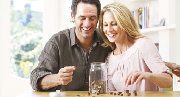 Middle aged couple counting coins