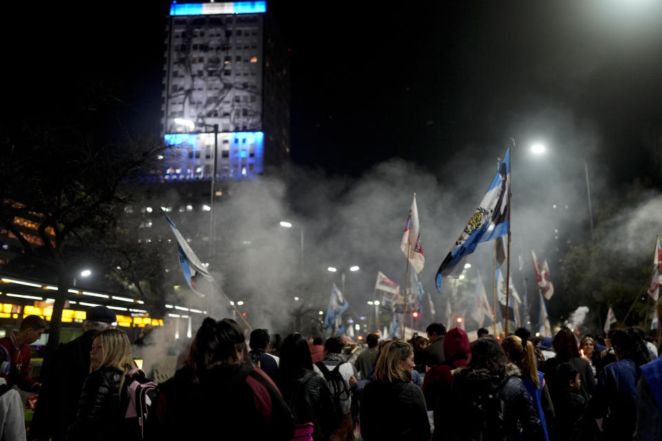 People gather to honor Argentina's late former first lady Maria Eva Duarte de Peron, better known as "Evita" outside the Social Development Ministry building in Buenos Aires, Argentina, Tuesday, July 26, 2022. Argentines commemorate the 70th anniversary of the death of their most famous first lady Evita who died of cancer on July 26, 1952, at the age of 33. (AP Photo/Natacha Pisarenko)