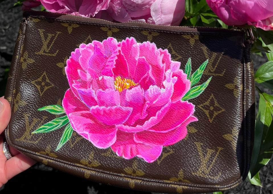 Louis Vuitton item with a pink flower painted onto it