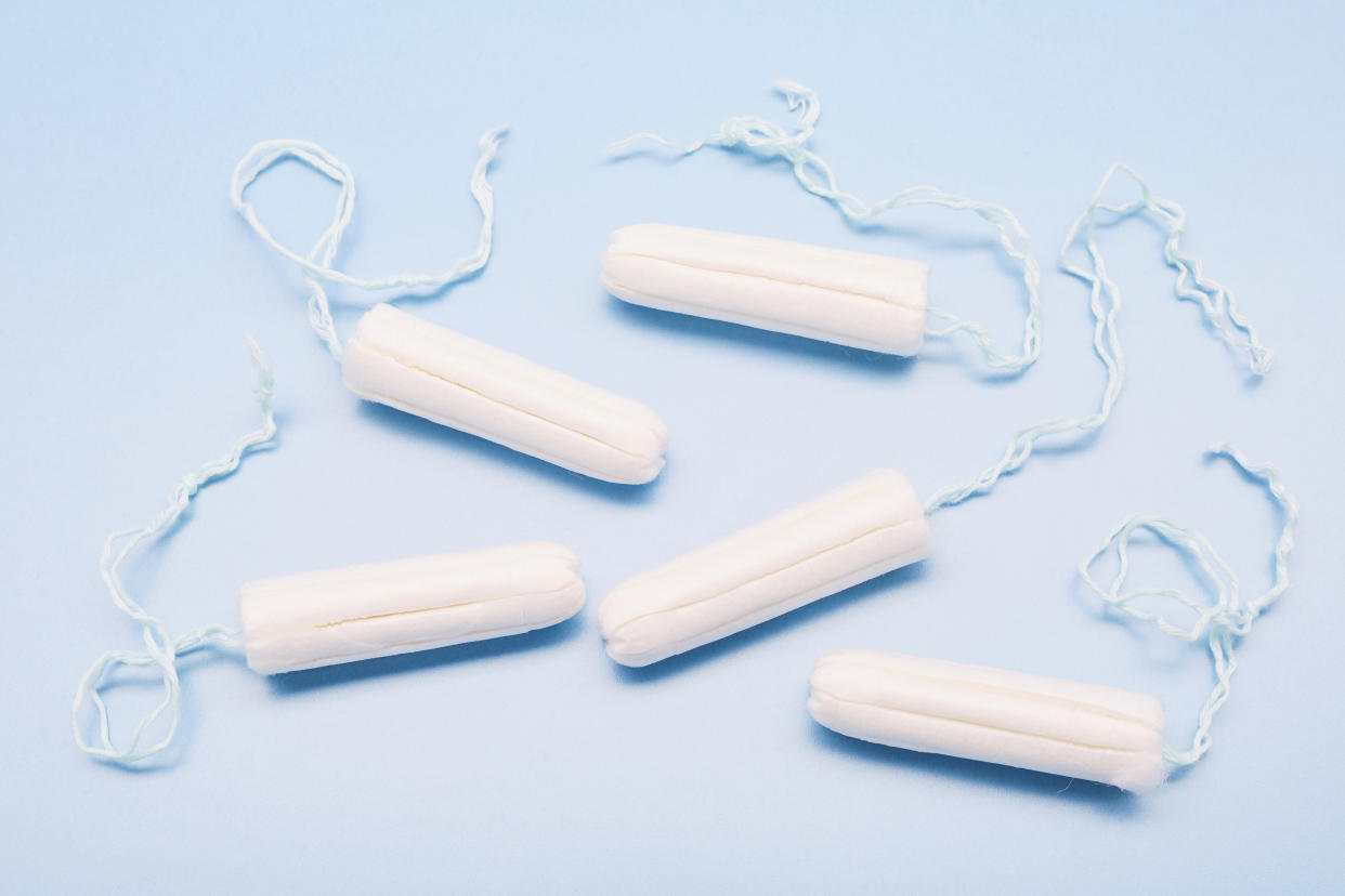 Five tampons on a blue background.