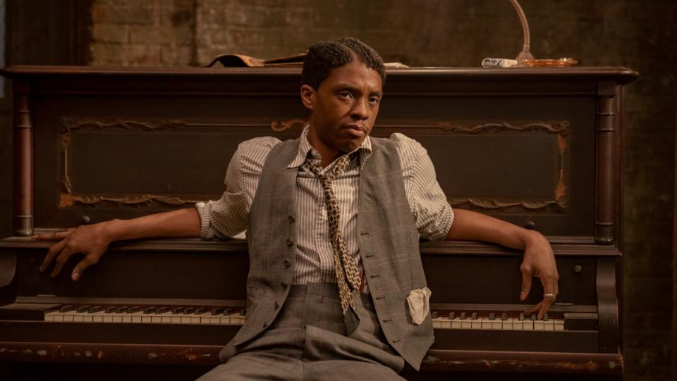 photo of chadwick boseman sitting in front of a piano in ma rainey's black bottom