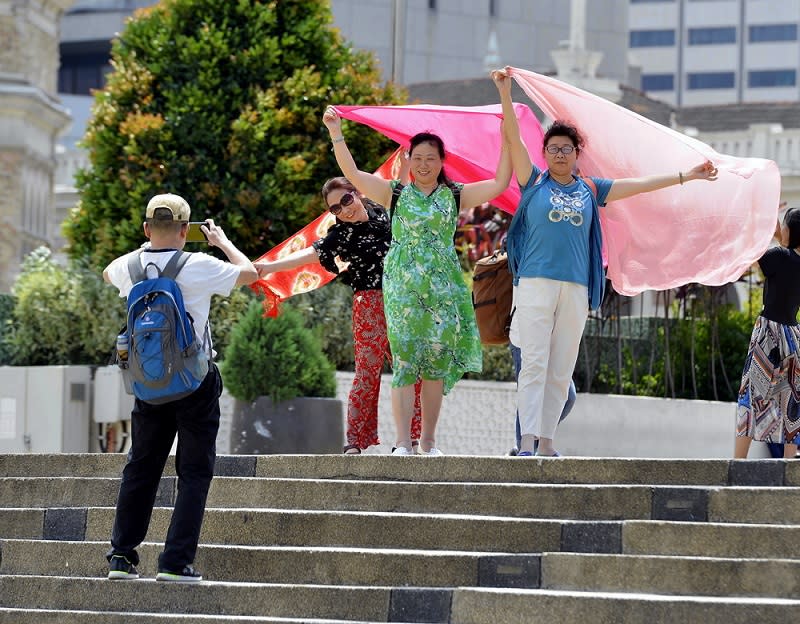 Tourists from China pose for pictures as they visit Dataran Merdeka in Kuala Lumpur February 16 2018. — Picture by Ham Abu Bakar