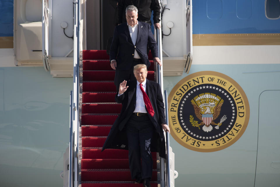 President Donald Trump departs Air Force One with Rep. Peter King, R-N.Y., on Sunday, Nov. 3, 2019, at Andrews Air Force Base, Md. after a trip to New York City to attend a mixed martial arts fight at Madison Square Garden. (AP Photo/Kevin Wolf)