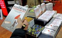 A customer holds a copy of a book by Belarussian author and Nobel Prize for Literature laureate Svetlana Alexievich in a bookstore in Berlin, Germany, October 8, 2015. REUTERS/Fabrizio Bensch