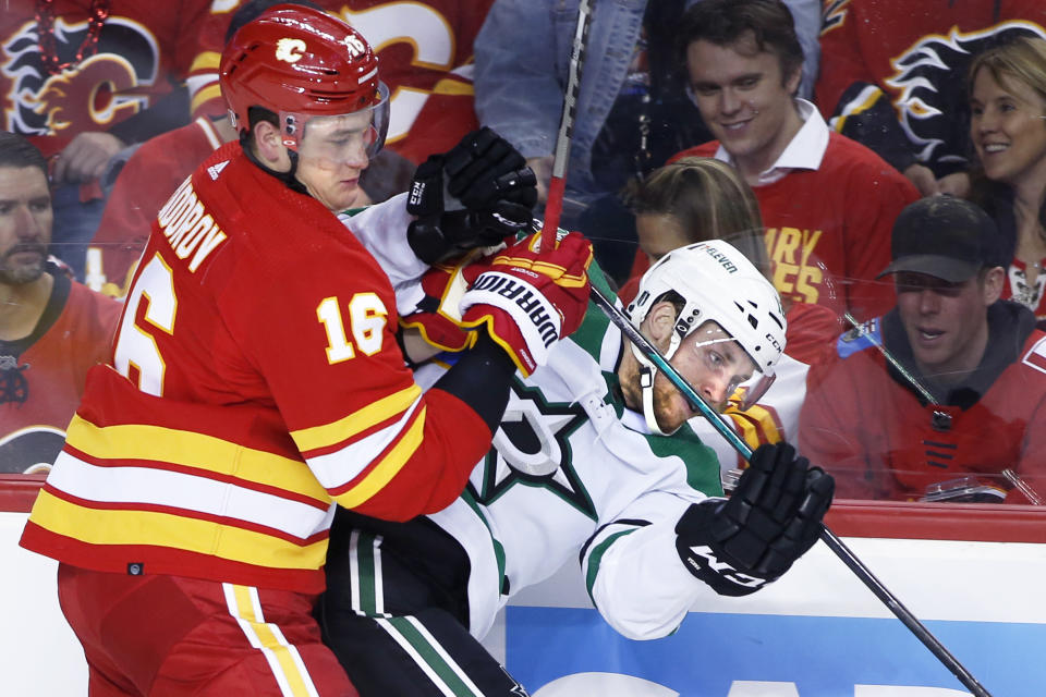 Calgary Flames defenseman Nikita Zadorov (16) checks Dallas Stars center Radek Faksa (12) during the second period of Game 5 of an NHL hockey Stanley Cup first-round playoff series, Wednesday, May 11, 2022 in Calgary, Alberta. (Larry MacDougal/The Canadian Press via AP)