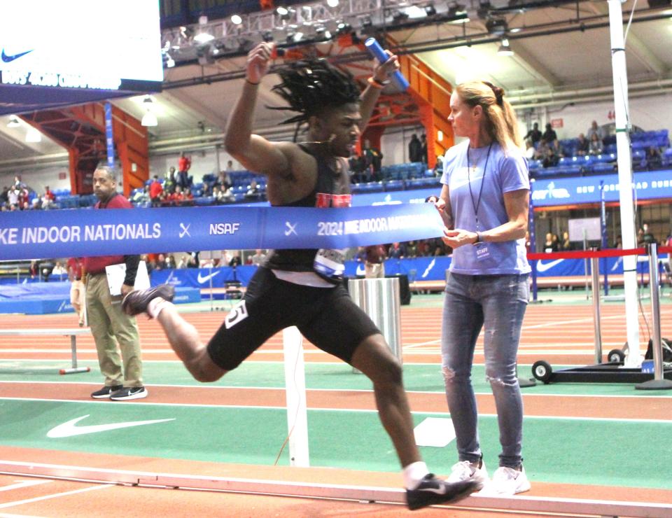 Jaquan Johnson breaks the finish-line tape as North Rockland wins the boys 4x200 relay championship at Nike Indoor Nationals at The Armory March 9, 2024. North Rockland, wose team also included Javon Lawrence, Darwin Almonte and Naji Mosley, broke its school record in the race.