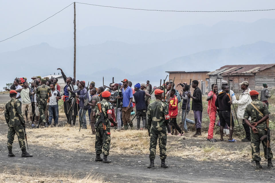 Demonstrators face police during a protest against the United Nations peacekeeping force (MONUSCO) deployed in the Democratic Republic of the Congo in Sake, some 15 miles (24 kms) west of Goma, Wednesday July 27, 2022. Officials say more than 15 people have been killed and dozens injured during the demonstrations against the UN mission in the country, heading into their third day. (AP Photo/Moses Sawasawa)