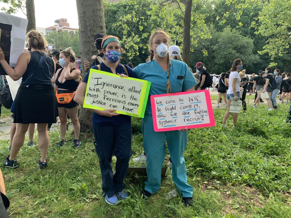 Lauren Frisk and Kassandra Rice, two nurses who traveled to New York to assist with the city's response to the coronavirus, joined protests against racial injustice Thursday in Brooklyn. (Photo by Yahoo Sports)