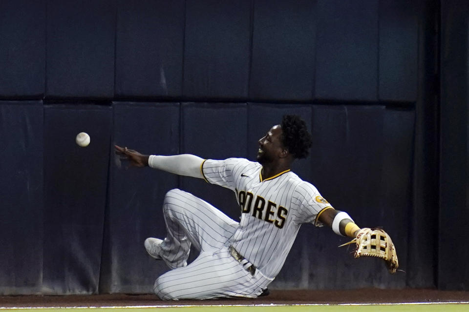 San Diego Padres left fielder Jurickson Profar can't reach a foul ball hit by St. Louis Cardinals' Tommy Edman during the sixth inning of a baseball game Tuesday, Sept. 20, 2022, in San Diego. (AP Photo/Gregory Bull)