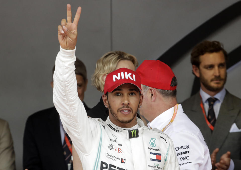 Mercedes driver Lewis Hamilton of Britain celebrates on the podium after winning the Monaco Formula One Grand Prix race, at the Monaco racetrack, in Monaco, Sunday, May 26, 2019. (AP Photo/Luca Bruno)